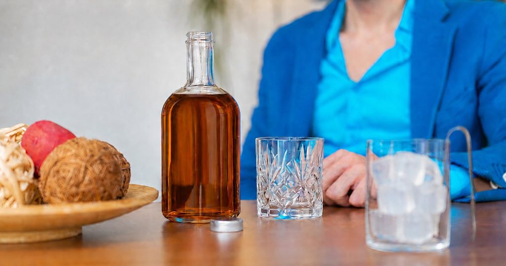 Person struggling with alcohol addiction and warning signs of dependence