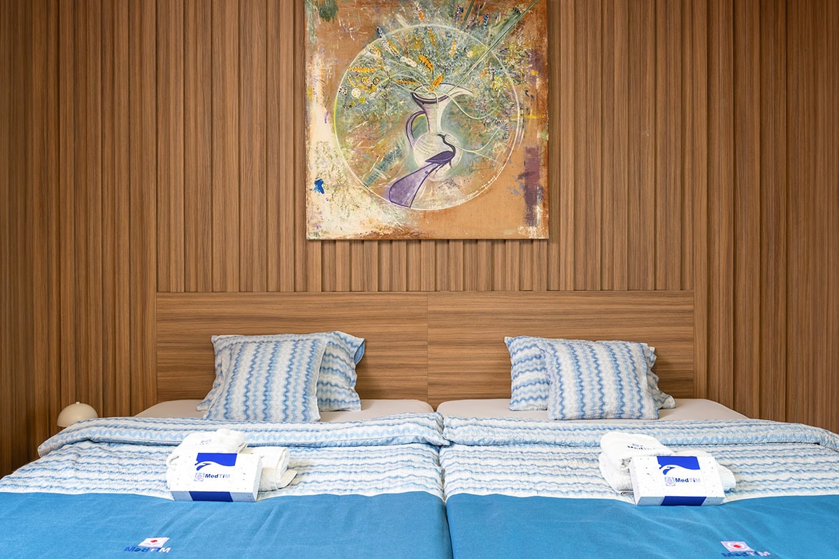 Single room with a spacious double bed for comfortable patient accommodation